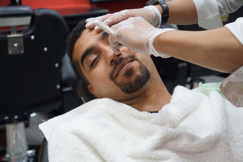 Barber using straight razor for precise shaving technique